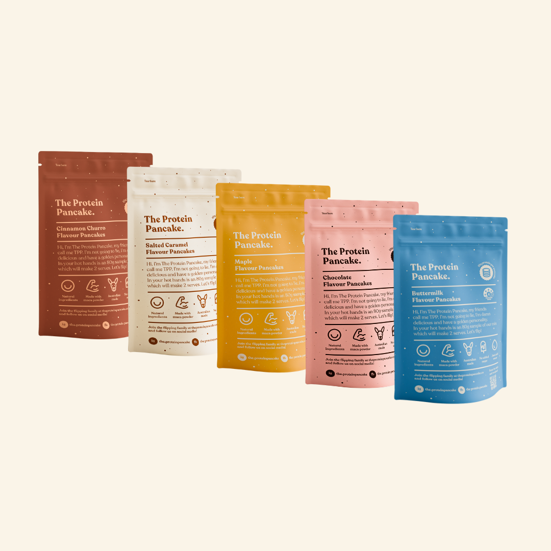 A variety of colorful protein pancake mix bags in different flavors.